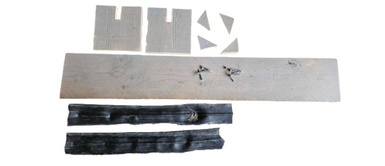 Afbeelding met de losse onderdelen van een houten snowboard klem